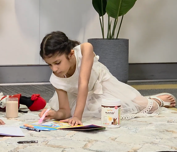 Child enjoying creative time with Joyzee nutrition products